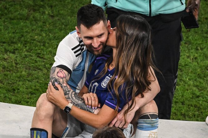 Lionel Messi striker's wife Antonela Roccuzzo kisses him after winning the 2022 World Cup