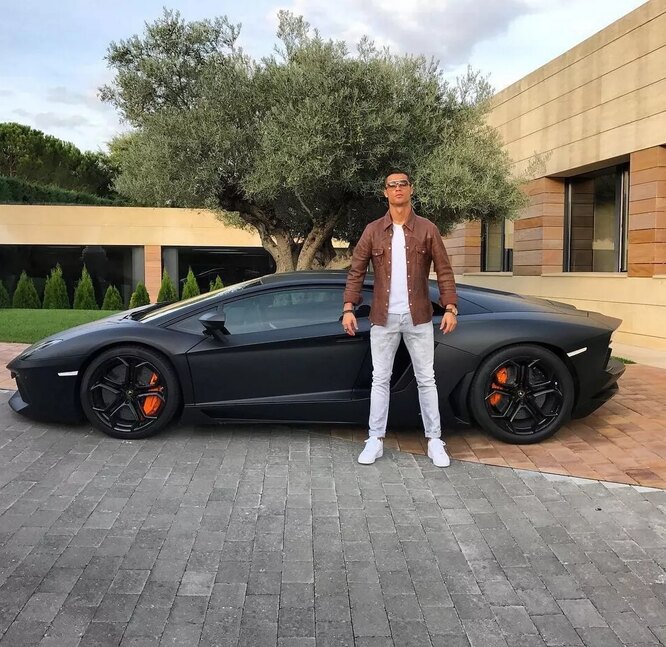 Cristiano Ronaldo next to his Lamborghini Aventador